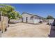 Spacious backyard with mature tree offers plenty of room for relaxation and outdoor activities at 16523 W Desert Bloom St, Goodyear, AZ 85338