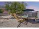 Relaxing backyard setup with hammock and shaded area, perfect for outdoor enjoyment at 16523 W Desert Bloom St, Goodyear, AZ 85338