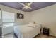 This bedroom has an accent colored ceiling, and a large window that offers an abundance of light at 16523 W Desert Bloom St, Goodyear, AZ 85338