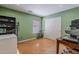 This room is well lit by the light from the window and ceiling and contains a desk and shelving at 16523 W Desert Bloom St, Goodyear, AZ 85338