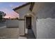 Inviting entryway with decorative door and well-maintained stucco exterior at 16523 W Desert Bloom St, Goodyear, AZ 85338