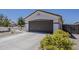 Single Gathering house with a two car garage, concrete driveway and desert landscaping at 16523 W Desert Bloom St, Goodyear, AZ 85338