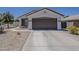 Single Gathering house with a two car garage and low maintenance landscaping at 16523 W Desert Bloom St, Goodyear, AZ 85338