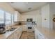 Spacious kitchen featuring stainless steel appliances and white cabinets at 16523 W Desert Bloom St, Goodyear, AZ 85338
