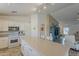 Kitchen showcases island seating, white cabinets, and views to adjacent spaces at 16523 W Desert Bloom St, Goodyear, AZ 85338