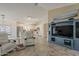 Open-concept living area featuring tile floors and an entertainment center at 16523 W Desert Bloom St, Goodyear, AZ 85338