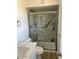 Updated bathroom features a modern shower with marble-style tiles, and a sleek vanity at 18045 N 20Th N Ln, Phoenix, AZ 85023