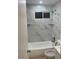 Stylish bathroom with a modern shower/tub combo, complete with marble-style tile backsplash and niches at 18045 N 20Th N Ln, Phoenix, AZ 85023