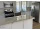 Kitchen with granite countertops, stainless steel appliances, a built-in microwave, and updated cabinetry at 18045 N 20Th N Ln, Phoenix, AZ 85023