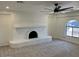 Bright living room features a white-painted brick fireplace, arched window, and modern ceiling fan at 18045 N 20Th N Ln, Phoenix, AZ 85023
