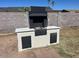 Outdoor brick grill in a well-maintained backyard, perfect for outdoor cooking and entertaining at 18045 N 20Th N Ln, Phoenix, AZ 85023