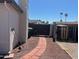 Fenced side yard with brick pathway and gravel groundcover under a clear blue sky at 18045 N 20Th N Ln, Phoenix, AZ 85023