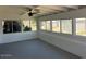 Enclosed sun room with brick accent wall and windows for natural light. Features ceiling fan for comfort at 18045 N 20Th N Ln, Phoenix, AZ 85023