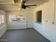 Bright sun room with white brick accent wall and views of the backyard, complete with a ceiling fan at 18045 N 20Th N Ln, Phoenix, AZ 85023