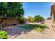 View of a large backyard with patio, desert landscaping and privacy wall at 2053 E Saddlebrook Ct, Gilbert, AZ 85298