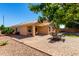 Paver patio in backyard with seating area, turf, and desert landscaping at 2053 E Saddlebrook Ct, Gilbert, AZ 85298
