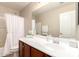 Bright bathroom with a shower-tub, ample counterspace, and a large mirror at 2053 E Saddlebrook Ct, Gilbert, AZ 85298