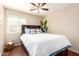 Cozy bedroom with a built-in headboard and a ceiling fan at 2053 E Saddlebrook Ct, Gilbert, AZ 85298