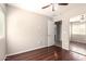 Bedroom featuring wood floors, a ceiling fan and a full-length closet at 2053 E Saddlebrook Ct, Gilbert, AZ 85298