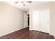 Neutral bedroom featuring a closet with sliding doors, and an entry door at 2053 E Saddlebrook Ct, Gilbert, AZ 85298