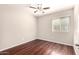 The bedroom is bright with wood floors, a ceiling fan and a large window at 2053 E Saddlebrook Ct, Gilbert, AZ 85298