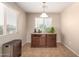 Bright dining area featuring a center island with bar seating, light fixture, and large windows at 2053 E Saddlebrook Ct, Gilbert, AZ 85298