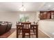 Cozy dining area with wood table set and a view into the kitchen area at 2053 E Saddlebrook Ct, Gilbert, AZ 85298