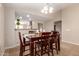 Bright dining area with wood table set, tile floor, and a view into the kitchen area at 2053 E Saddlebrook Ct, Gilbert, AZ 85298