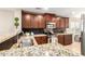 Well-lit kitchen with dark wood cabinetry, stainless steel appliances, and granite countertops at 2053 E Saddlebrook Ct, Gilbert, AZ 85298