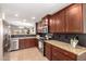 Well-lit kitchen with dark wood cabinetry, stainless steel appliances, and granite countertops at 2053 E Saddlebrook Ct, Gilbert, AZ 85298