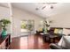 Living room with hardwood flooring, a ceiling fan, sliding glass doors and comfortable seating at 2053 E Saddlebrook Ct, Gilbert, AZ 85298