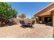 Paver patio features an outdoor dining set, bbq, and covered area perfect for entertaining in the backyard at 2053 E Saddlebrook Ct, Gilbert, AZ 85298