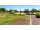 Community playground with green grass, covered picnic table, and playground equipment at 2053 E Saddlebrook Ct, Gilbert, AZ 85298