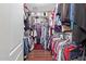 Spacious walk-in closet with ample storage, featuring hanging rods, shelves, and organized apparel at 2053 E Saddlebrook Ct, Gilbert, AZ 85298
