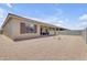 A covered patio, xeriscaping, and a block fence define this low maintenance backyard at 22788 E Orion Way, Queen Creek, AZ 85142