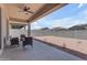 Outdoor living space with covered patio and seating offers a place to relax in the low maintenance backyard at 22788 E Orion Way, Queen Creek, AZ 85142