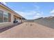 Low maintenance backyard features a covered patio with seating and a privacy wall to provide privacy and space at 22788 E Orion Way, Queen Creek, AZ 85142