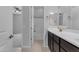 En-suite bathroom with a tiled floor, dark cabinetry, and a tub/shower combo at 22788 E Orion Way, Queen Creek, AZ 85142