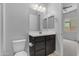 Bathroom featuring a dark vanity with a sink, toilet and mirror at 22788 E Orion Way, Queen Creek, AZ 85142
