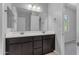 Bathroom featuring a dual sink vanity with dark cabinets and modern fixtures at 22788 E Orion Way, Queen Creek, AZ 85142