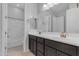 Bathroom featuring a dual sink vanity with dark cabinets and modern fixtures at 22788 E Orion Way, Queen Creek, AZ 85142