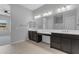 Bright bathroom featuring a double vanity, tile flooring, and a large mirror at 22788 E Orion Way, Queen Creek, AZ 85142