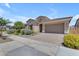 Attractive single-story home with a tiled roof, paver driveway, and well-maintained desert landscaping at 22788 E Orion Way, Queen Creek, AZ 85142