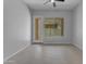 Living room with tile floor featuring natural light and backyard access at 22788 E Orion Way, Queen Creek, AZ 85142