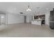Open-concept living space with tile flooring, a kitchen island, and plenty of natural light at 22788 E Orion Way, Queen Creek, AZ 85142