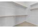 Walk-in closet featuring white walls, carpet, and wooden racks for organized storage at 22788 E Orion Way, Queen Creek, AZ 85142