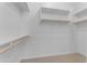 Walk-in closet with bright white walls, carpet, and custom wooden shelving at 22788 E Orion Way, Queen Creek, AZ 85142