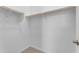 Walk-in closet with wooden rods and shelf offer ample storage space at 22788 E Orion Way, Queen Creek, AZ 85142