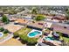 Aerial view highlighting a property with a backyard pool, patio area, and lush greenery at 2338 E Javelina Ave, Mesa, AZ 85204