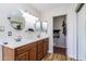 Bathroom featuring dual sinks, wood cabinets, and views into the toilet and shower areas at 2338 E Javelina Ave, Mesa, AZ 85204